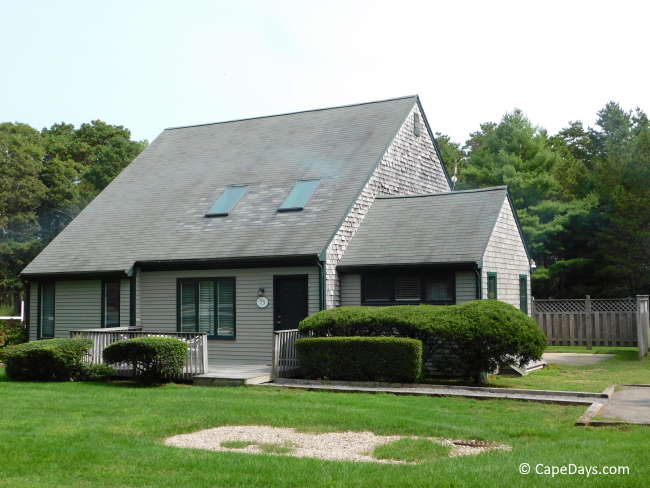 View of vacation rental home surrounded by lush lawn and shrubbery