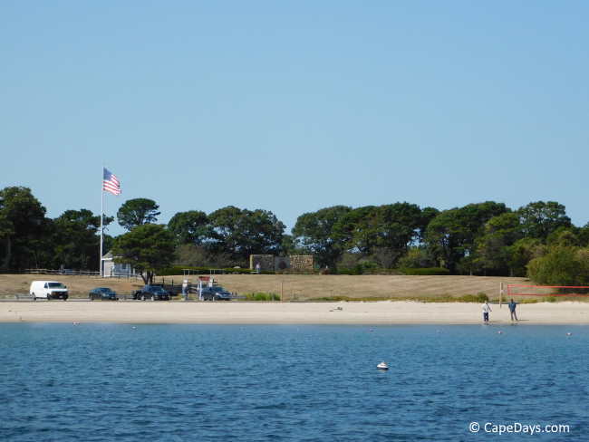 Calm blue water, beachfront and veterans memorial on the hill