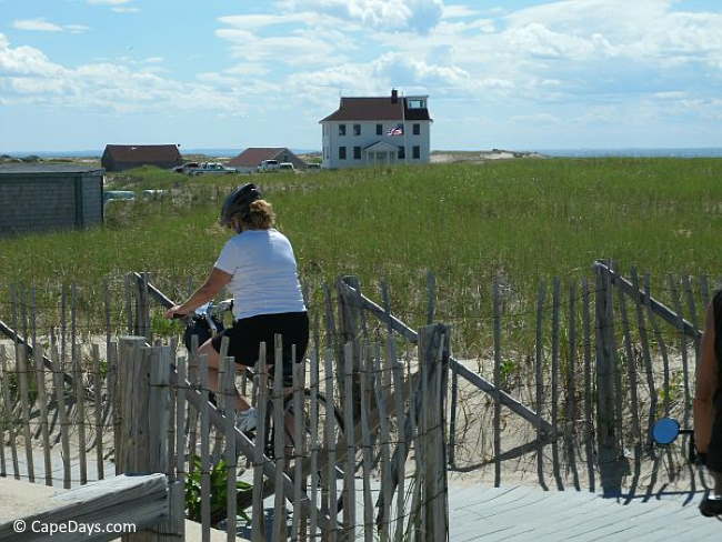 Lady riding her bike at Race Point