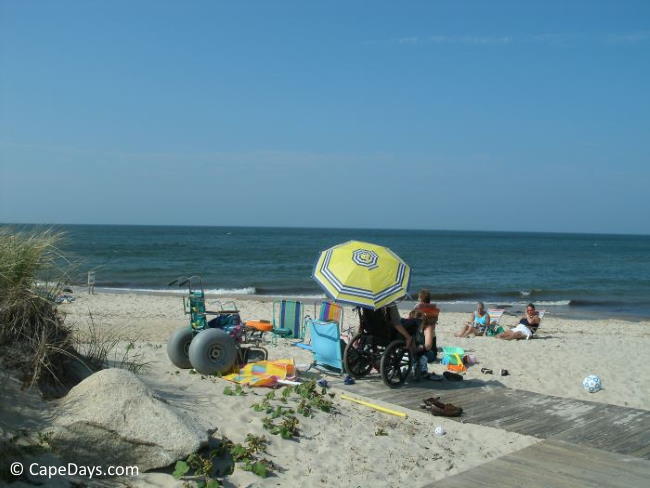 Vacationers using wheelchairs on a Cape Cod Bay beach