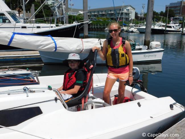 Instructor and sailor on sailboat at dock