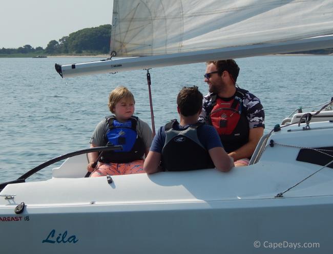 Sailor and instructors on sailboat on the water