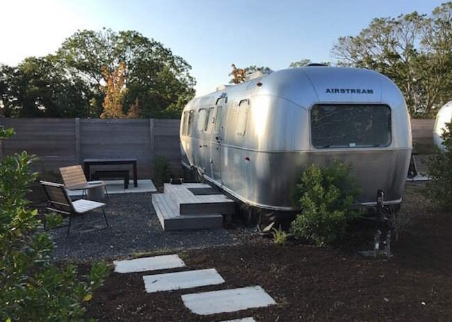 Airstream camper and outdoor fire pit seating area Airstream camper and outdoor fire pit seating area