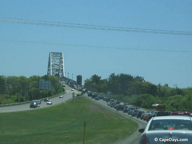Long line of cars and trucks waiting to cross bridge over the Cape Cod Canal