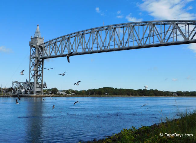 Cape Cod Canal Railroad Bridge in raised position with birds flying in the foreground
