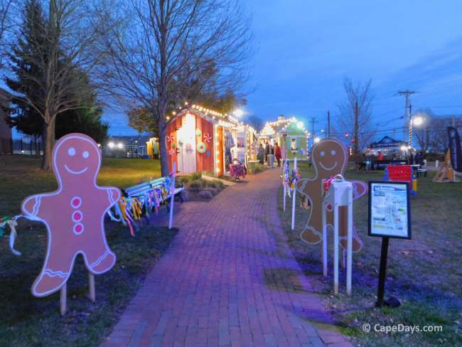 Gingerbread decorations and lighted vendor booths at a Cape Cod holiday market