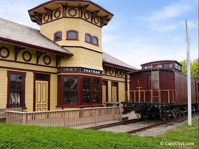 Historic Chatham Railroad Museum depot with restored caboose on the tracks.