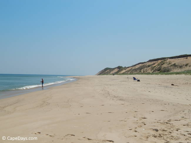 Lone surf fisherman flycasting into the Atlantic Ocean at Coast Guard Beach in Truro