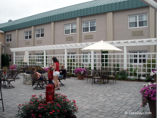 Level, hard-surfaced outdoor patio with umbrella tables and fire pit Level, hard-surfaced outdoor patio with umbrella tables and fire pit