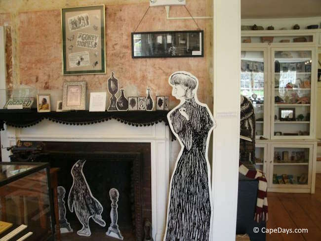 Interior of the Edward Gorey House Museum showing original artwork and illustrated figures.