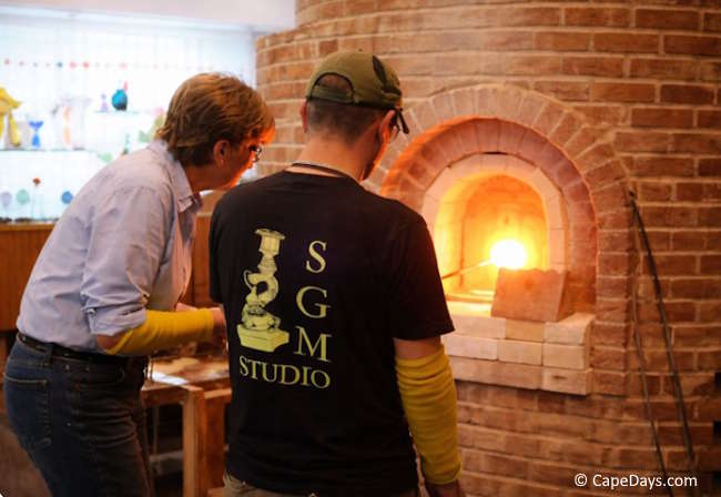 Instructor guiding a student at the glass furnace during a hands-on workshop at Sandwich Glass Museum Instructor guiding a student at the glass furnace during a hands-on workshop at Sandwich Glass Museum