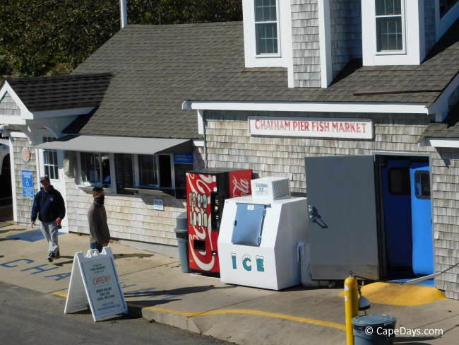 weathered shingle building with sign: Chatham Pier Fish Market