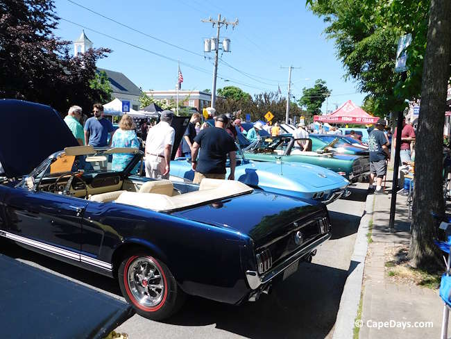 People looking at vintage autos on display along Main Street in Hyannis