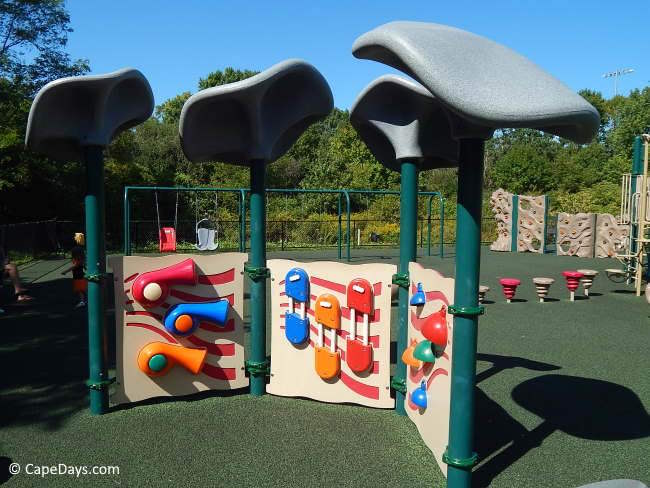 Three large interactive play panels at an inclusive playground on Cape Cod, with colorful elements for sensory play Three large interactive play panels at an inclusive playground on Cape Cod, with colorful elements for sensory play