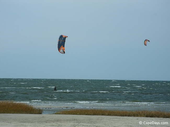 Kite surfers skimming the whitecaps Kite surfers skimming the whitecaps