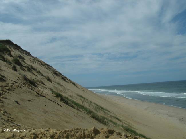 Gigantic bluff and waves rolling in to the beach at Long Nook in Truro MA