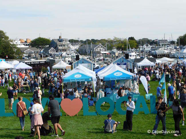 Crowd browsing vendor tents at Love Local Fest on Hyannis Harbor