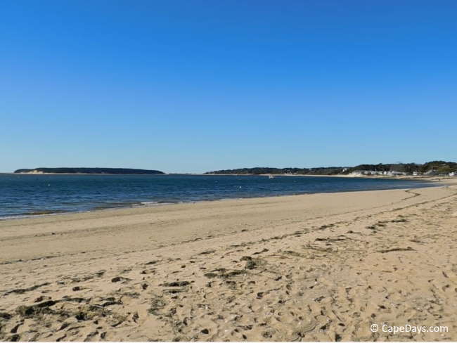 Sandy beach along calm bay-side waters