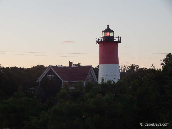 Red and white lighthouse and weathered-shingle keepers house Red and white lighthouse and weathered-shingle keepers house