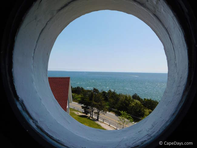 View through the porthole inside Nobska Light, looking out toward Vineyard Sound on a clear day.