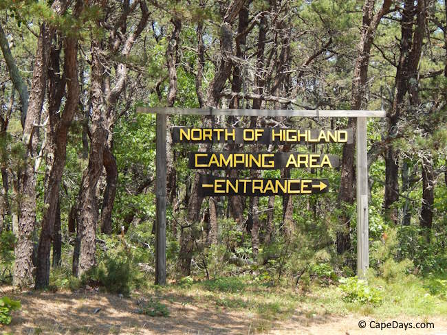 Tall pine trees and welcome sign at the entrance to North of Highland Campground Tall pine trees and welcome sign at the entrance to North of Highland Campground