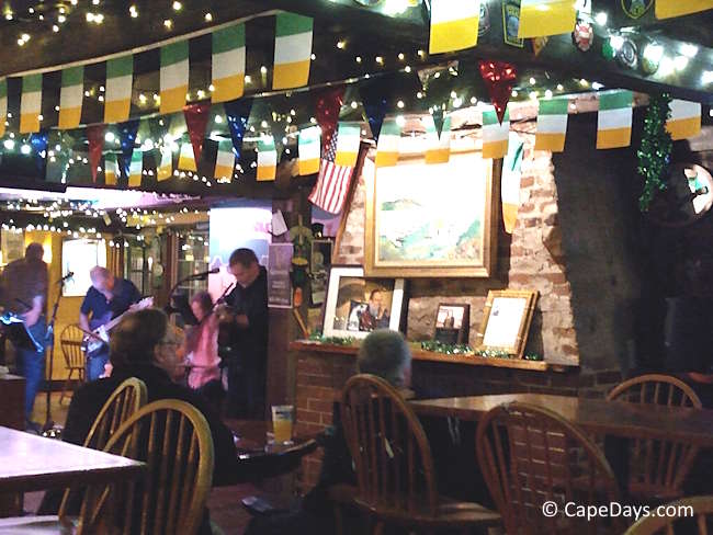 Interior of O’Shea’s Olde Inn in Dennis with live music, diners seated at tables