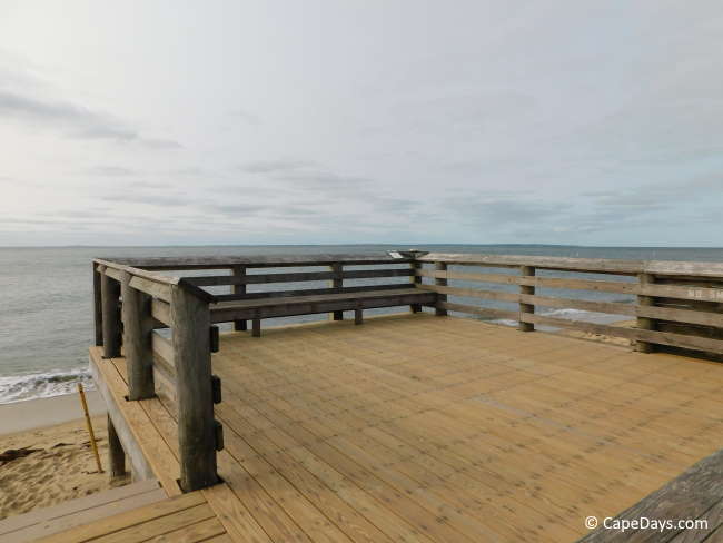 Large wooden viewing platform with built-in bench seating, views of Nantucket Sound
