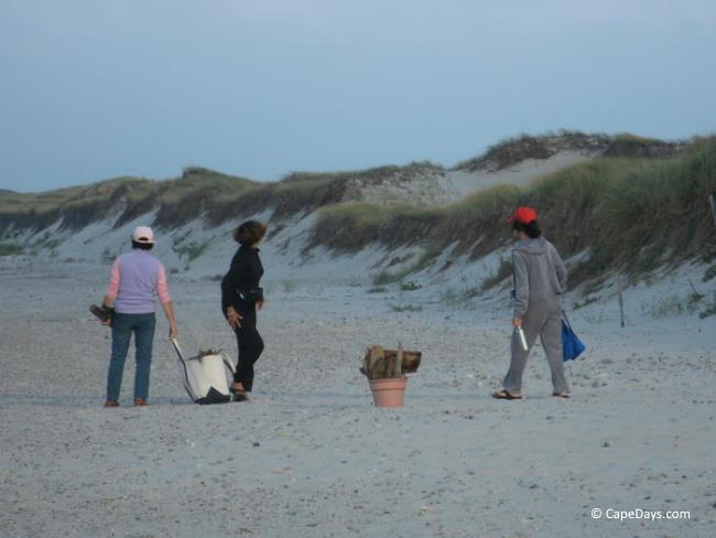 Ladies on the beach with their supplies for an evening campfire