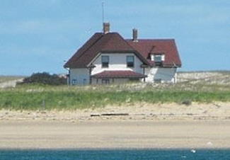 White lighthouse keepers house with red roof