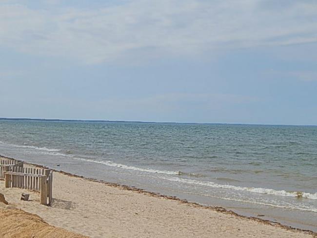 Picket fence on the beach and view of the Bay Picket fence on the beach and view of the Bay