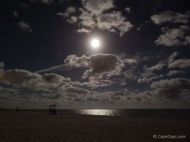 Big, bright "super moon" lighting up the beach and reflecting off the ocean water