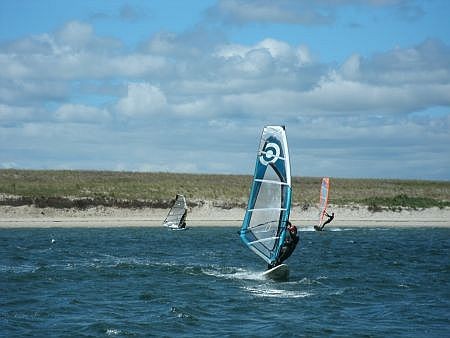 man windsurfing near kalmus beach