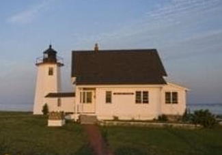 Wings Neck Light and keepers house in the glow of the setting sun