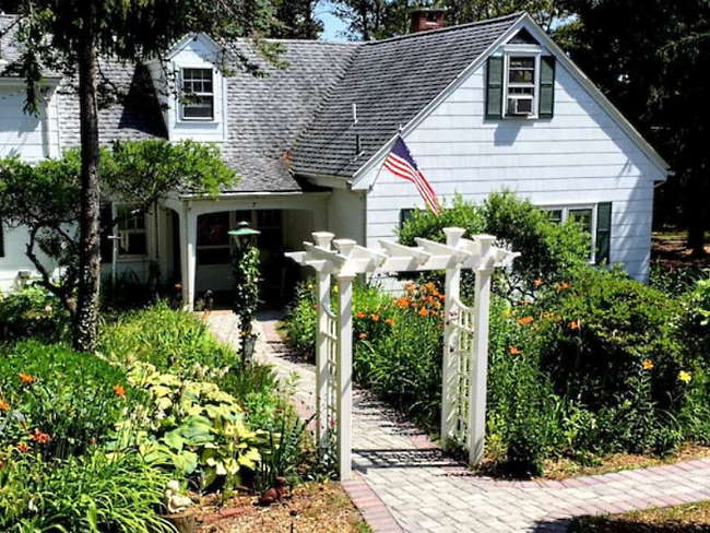 Two-storey home surrounded by trees and gardens